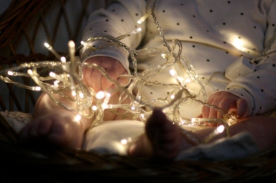baby and christmas lights